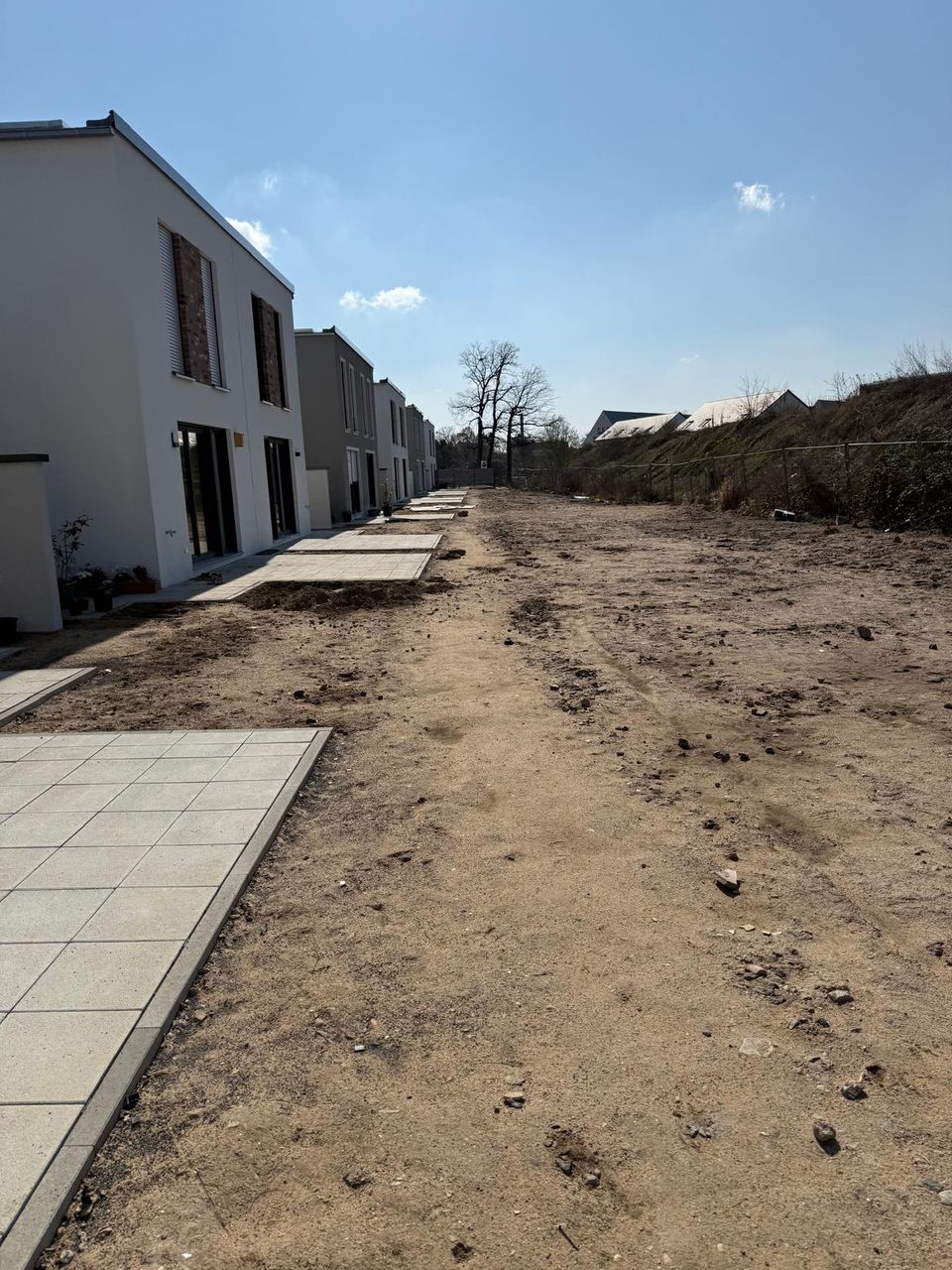 Neubau mit angelegten Wegen und Terrassenplatten